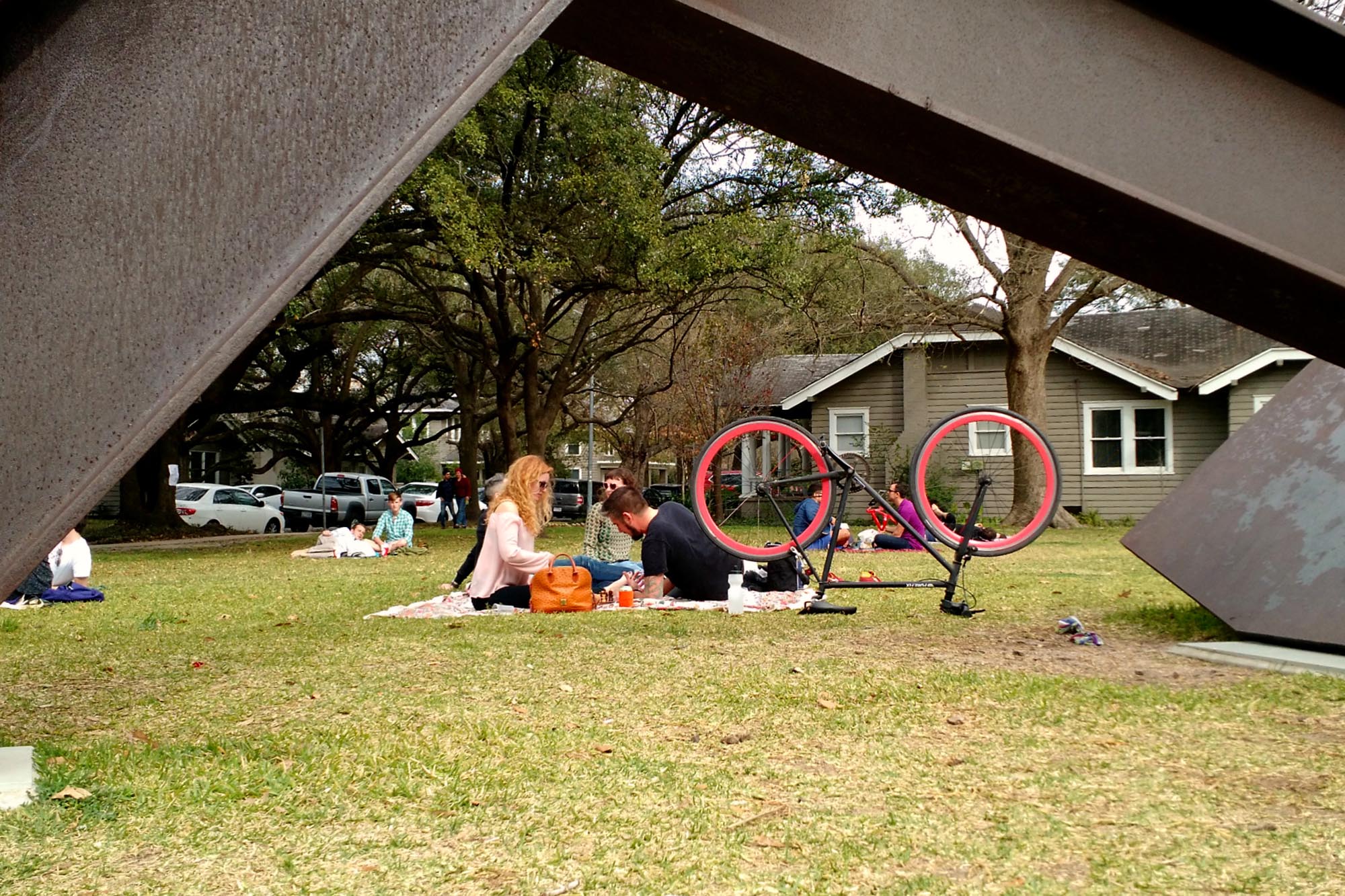 People lay on the gras in a park in the Montrose area.