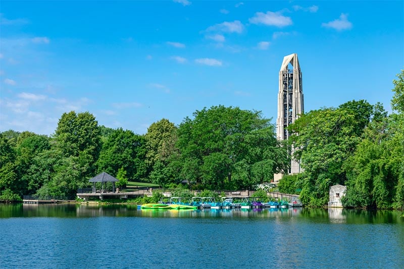 A large building rises above boats and a small lakefront in Naperville outside Chicago