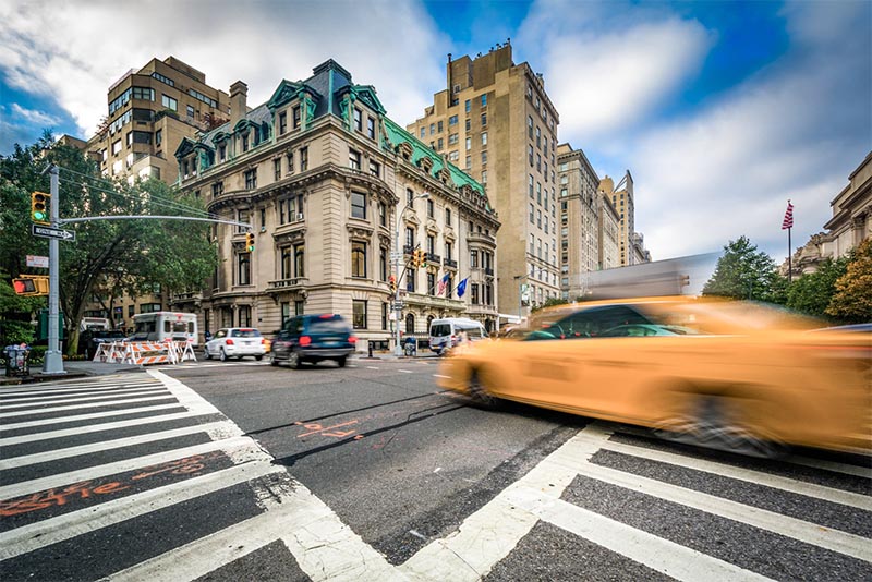A taxi cab speeds through the Upper East Side in New York City