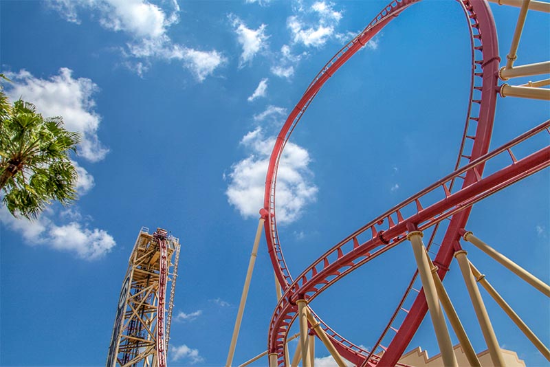 A partial shot of a looping red rollercoaster in Orlando