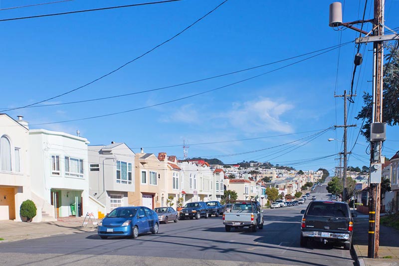 neighborhood street with white stucco homes in the bay area