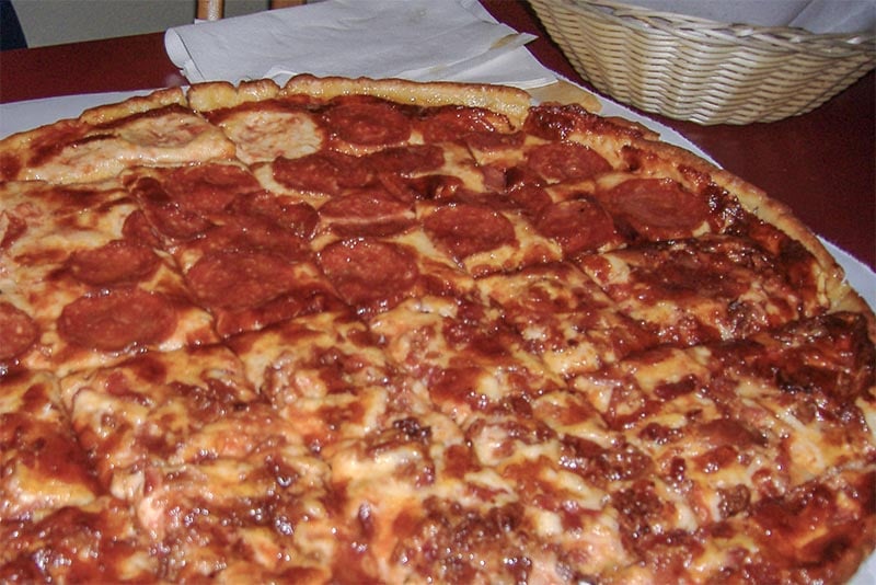 A Chicago tavern-style pizza with square-cut slices