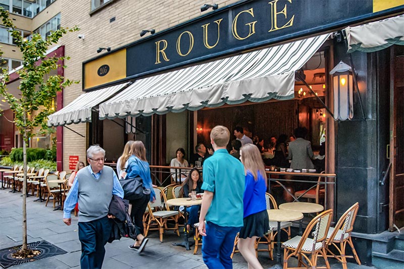 People walking past diners at Rouge restaurant in Philadelphia