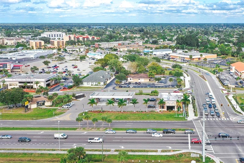 An aerial view of a shopping center and street view in Port Charlotte Florida