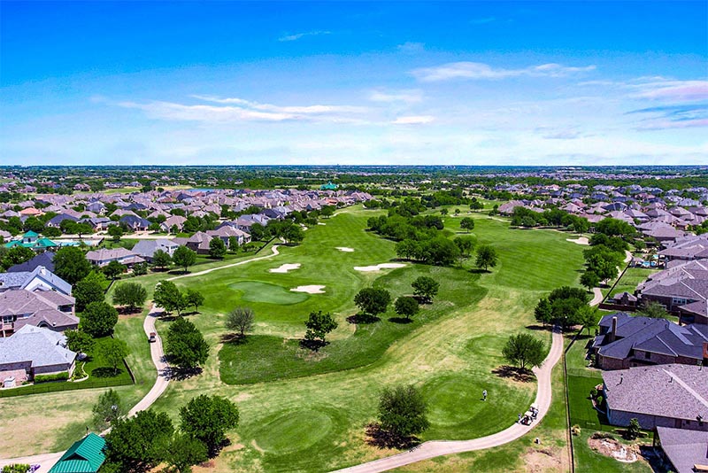 An aerial view of a golf course in a community in Prosper, Texas