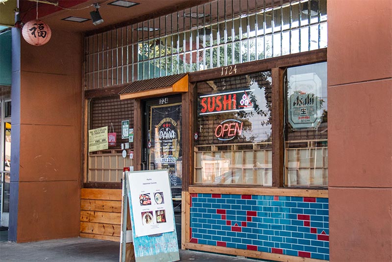 A sushi restaurant with glowing neon signs in Sacramento