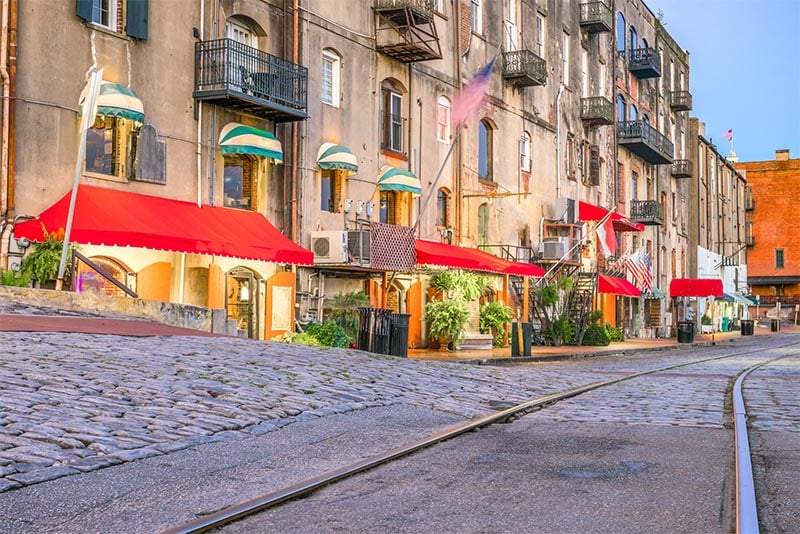 A row of businesses at evening with their lights on in Savannah Georgia