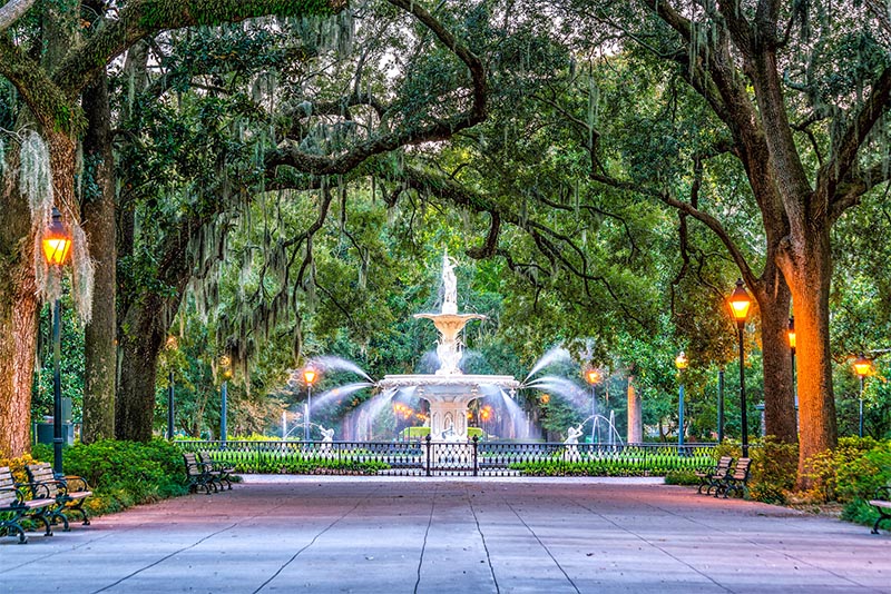 A large fountain surrounded by willow trees in Savannah Georgia