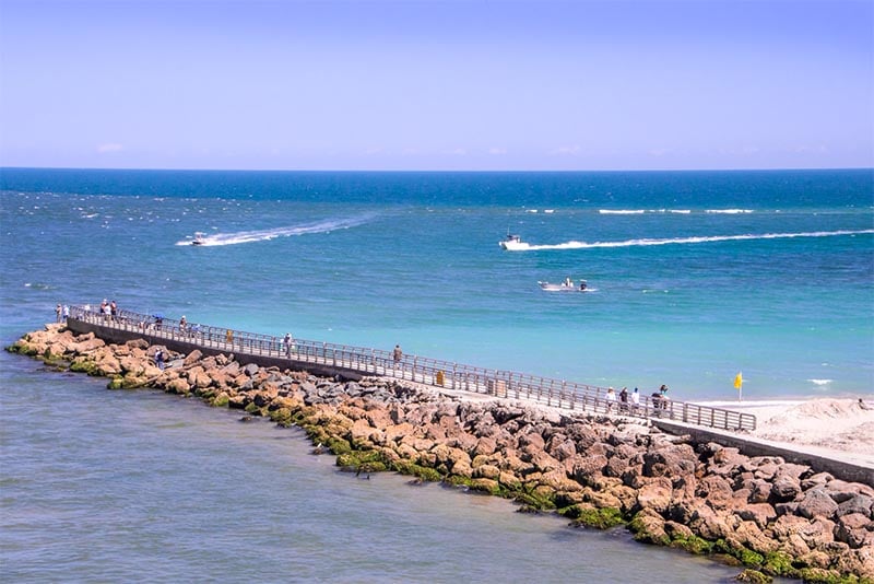 A pier with people near the ocean in Sebastian Florida