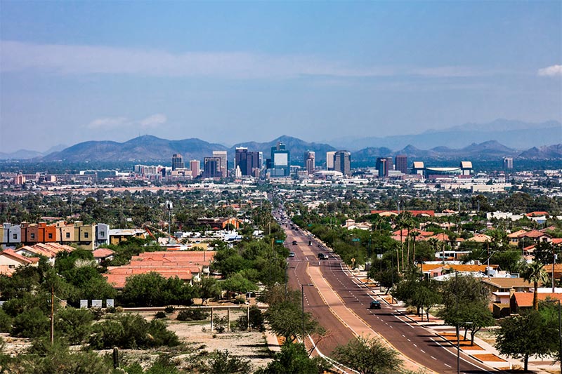 A large highway cuts across the landscape into Downtown Phoenix