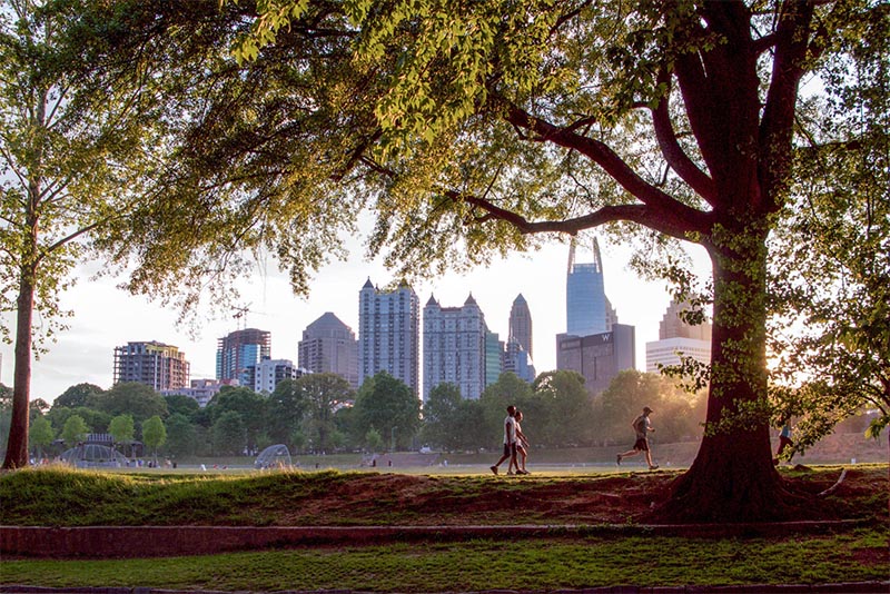 People running along a trail in Piedmont Park in Atlanta