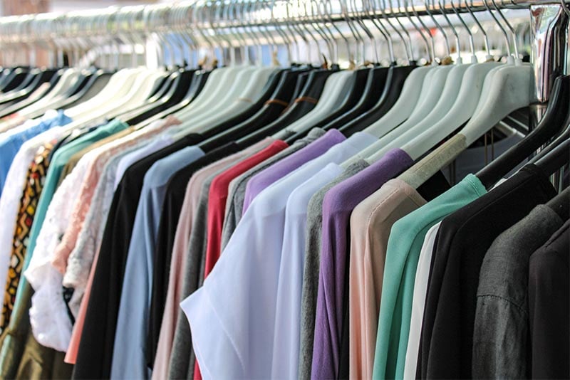 A rack of clothing at a thrift shop