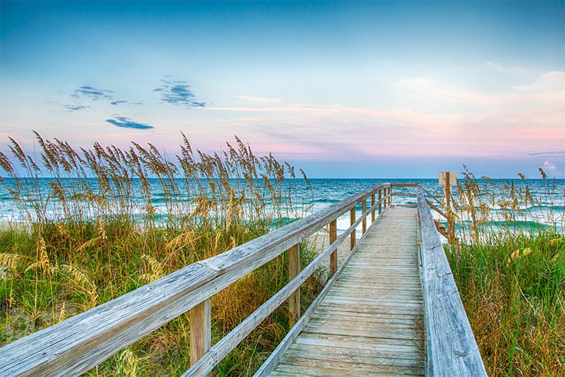 A wooden path leads to a beach in Wilmington North Carolina