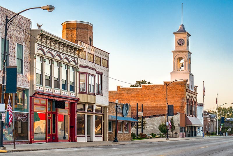 A row of small businesses in a small town in front of an empty street