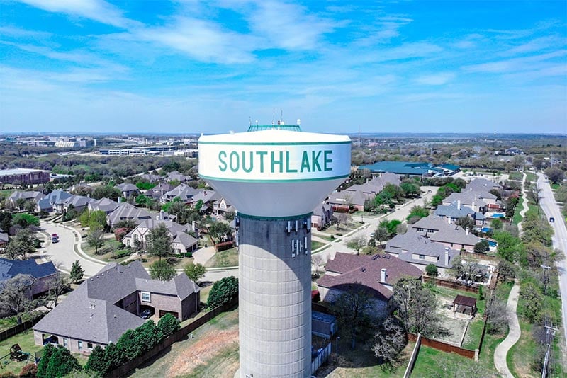 A view of the Southlake, Texas water tower with residential homes behind it