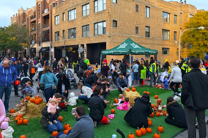 Many families outside celebrating Halloween at Trick-or-Treat on Southport in Chicago.