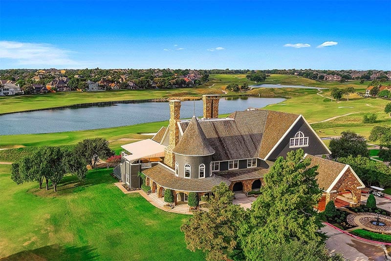 An aerial view of a large clubhouse in the Stonebridge Ranch community in Texas