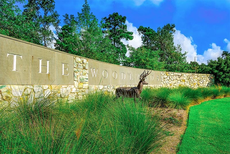The community sign and a statue of a deer outside The Woodlands community in Texas