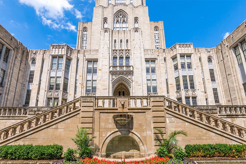 The University of Pittsburgh with a fountain in the center of the photo