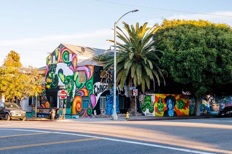 Colorful building wrapped around Venice intersection with lots of art