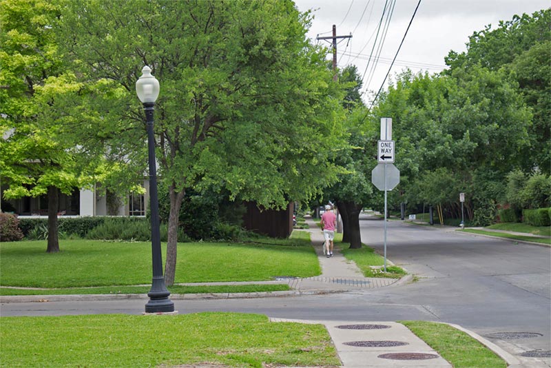 man walking down neighborhood street