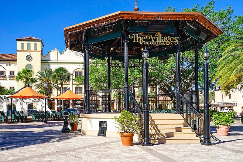 A gazebo in a courtyard with a sign that says The Villages