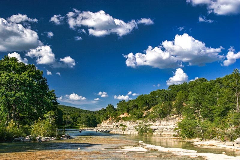 A river runs through rocks and hills in Wimberley, Texas outside Austin